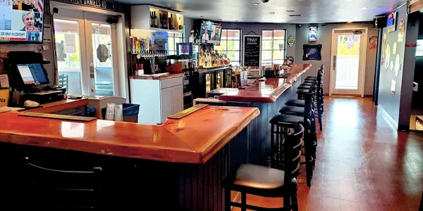 Warm wood bar and seating inside Tualatin Station Bar and Grill